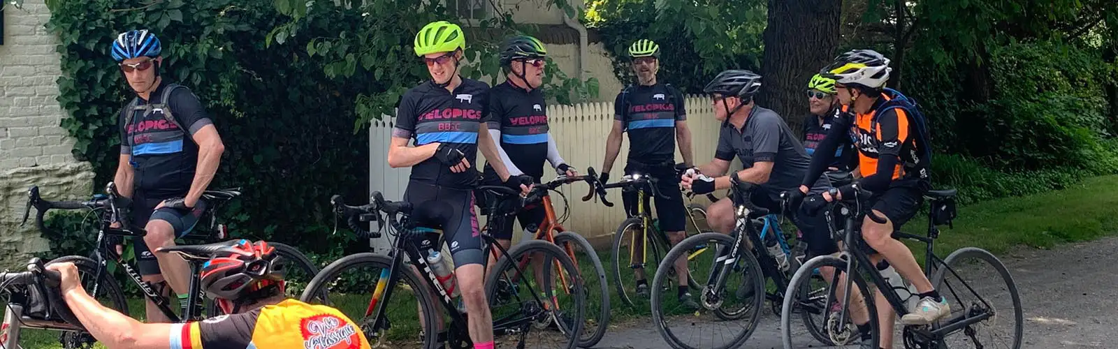 Image of VeloPigs members watching member fix their flat.